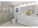 Bright bathroom with double vanity, framed mirror and a glass enclosed tiled shower at 216 Horseshoe Pl # 25, Angier, NC 27501