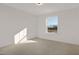 A clean and simple bedroom with natural light streaming through the window at 216 Horseshoe Pl # 25, Angier, NC 27501