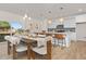 Open-concept dining area with modern table, stylish chairs, and kitchen island view at 216 Horseshoe Pl # 25, Angier, NC 27501