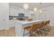 Modern kitchen boasts a large island, stylish pendant lighting, and stainless steel appliances at 216 Horseshoe Pl # 25, Angier, NC 27501