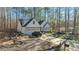 White farmhouse with a large yard and wooded area at 225 Rudd Rd, Youngsville, NC 27596