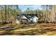 Spacious backyard with a large grassy area and a screened porch at 225 Rudd Rd, Youngsville, NC 27596