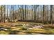 Large backyard with a wooden fence and fire pit area at 225 Rudd Rd, Youngsville, NC 27596
