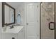 Clean bathroom with a single vanity, shower and mirror at 225 Rudd Rd, Youngsville, NC 27596