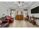 Relaxing bedroom with ceiling fan, hardwood floors and large dresser at 225 Rudd Rd, Youngsville, NC 27596