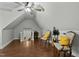Spacious bonus room with hardwood floors and two chairs at 225 Rudd Rd, Youngsville, NC 27596