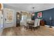 Bright dining room with wood flooring, chandelier, and seating for six at 225 Rudd Rd, Youngsville, NC 27596