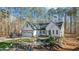 White farmhouse exterior with landscaped yard and water feature at 225 Rudd Rd, Youngsville, NC 27596