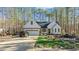 White farmhouse exterior with a spacious driveway at 225 Rudd Rd, Youngsville, NC 27596