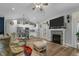 Open living room with fireplace and kitchen view at 225 Rudd Rd, Youngsville, NC 27596