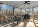 Relaxing screened porch with wooden floors and outdoor seating at 225 Rudd Rd, Youngsville, NC 27596