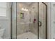 Modern shower with glass enclosure and neutral tile at 225 Rudd Rd, Youngsville, NC 27596
