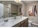 Double vanity bathroom with a large mirror and a walk-in shower at 242 Broomside Ave, Raleigh, NC 27603