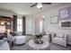 Bright living room featuring large windows and a cozy seating area at 242 Broomside Ave, Raleigh, NC 27603
