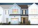 Two-story townhome with light-grey siding, dark-grey roof, and a brick entryway at 246 Broomside Ave, Raleigh, NC 27603