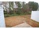 Private backyard with a small patio and trees at 2530 Friedland Pl # 104, Raleigh, NC 27617