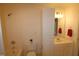 Clean bathroom with a shower/tub combo and linen cabinet at 2530 Friedland Pl # 104, Raleigh, NC 27617