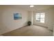 Well-lit bedroom with carpet, large window, and neutral walls at 2530 Friedland Pl # 104, Raleigh, NC 27617
