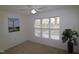 Bedroom with large window, ceiling fan, and coastal art at 2530 Friedland Pl # 104, Raleigh, NC 27617