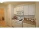 Kitchen with granite countertops and white cabinets at 2530 Friedland Pl # 104, Raleigh, NC 27617