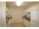 Galley kitchen featuring granite countertops and white cabinets at 2530 Friedland Pl # 104, Raleigh, NC 27617