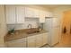 Kitchen boasts granite countertops and white cabinets at 2530 Friedland Pl # 104, Raleigh, NC 27617