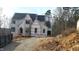 Two-story house under construction, featuring a charming architectural design and large windows at 286 W Beech Slope Ct, Chapel Hill, NC 27517