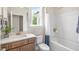 Clean bathroom with a bathtub, shower, and updated vanity at 313 Umstead St, Sanford, NC 27330