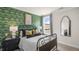 Cozy bedroom with a patterned wall, window seat, and dark-wood bed frame at 313 Umstead St, Sanford, NC 27330
