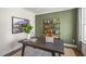 Home office with a large desk, green accent wall, and natural light at 313 Umstead St, Sanford, NC 27330
