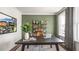 Home office with a large desk, green accent wall, and natural light at 313 Umstead St, Sanford, NC 27330