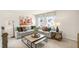 Spacious loft with sectional sofa, two windows, and artwork at 313 Umstead St, Sanford, NC 27330