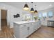 Modern kitchen with white cabinets, large island, and stainless steel appliances at 35 Mable Court # 3, Lillington, NC 27546