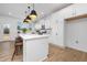White kitchen with island, stainless steel appliances, and breakfast bar at 35 Mable Court # 3, Lillington, NC 27546