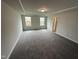 Spacious bedroom with grey carpet and two windows at 3704 Massey Pond Trl # Tessa, Raleigh, NC 27616