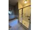 Walk-in shower with glass enclosure and shelves at 3920 Essex Garden Lane Ln # 103, Raleigh, NC 27612