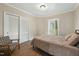 Comfortable bedroom with a bed, chair, and private access to the outdoors at 507 Hawkins Ave, Sanford, NC 27330