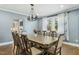 Spacious dining room with a large table, chandelier, and hardwood floors at 507 Hawkins Ave, Sanford, NC 27330