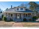 Charming two-story home with gray brick exterior and a welcoming front porch at 507 Hawkins Ave, Sanford, NC 27330