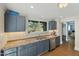 Modern kitchen with gray cabinets, stainless steel appliances, and granite countertops at 507 Hawkins Ave, Sanford, NC 27330