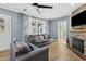 Spacious living room with hardwood floors, sofas, and a stone fireplace at 507 Hawkins Ave, Sanford, NC 27330