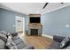 Living room featuring a stone fireplace and hardwood floors at 507 Hawkins Ave, Sanford, NC 27330