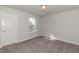 Bright bedroom with a window, carpet, and door at 55 Watermelon Dr, Franklinton, NC 27525