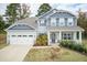 Two-story house with gray siding, stone accents, and a two-car garage at 55 Watermelon Dr, Franklinton, NC 27525