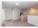 Upstairs hallway with carpet, two doors, and art piece at 55 Watermelon Dr, Franklinton, NC 27525