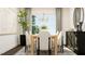 Elegant dining room with a large table, six chairs, and a statement chandelier at 1013 Aspen View Dr, Raleigh, NC 27610