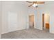 Comfortable bedroom with carpet, ceiling fan, and access to the bathroom and upstairs at 10947 Pendragon Pl, Raleigh, NC 27614