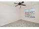 Bright bedroom featuring ceiling fan and neutral carpeting at 10947 Pendragon Pl, Raleigh, NC 27614