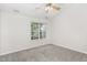 Spacious bedroom with carpeted floor, ceiling fan, and large window at 10947 Pendragon Pl, Raleigh, NC 27614