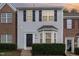 Two-story townhome with brick and siding exterior, landscaping, and a charming front entrance at 10947 Pendragon Pl, Raleigh, NC 27614